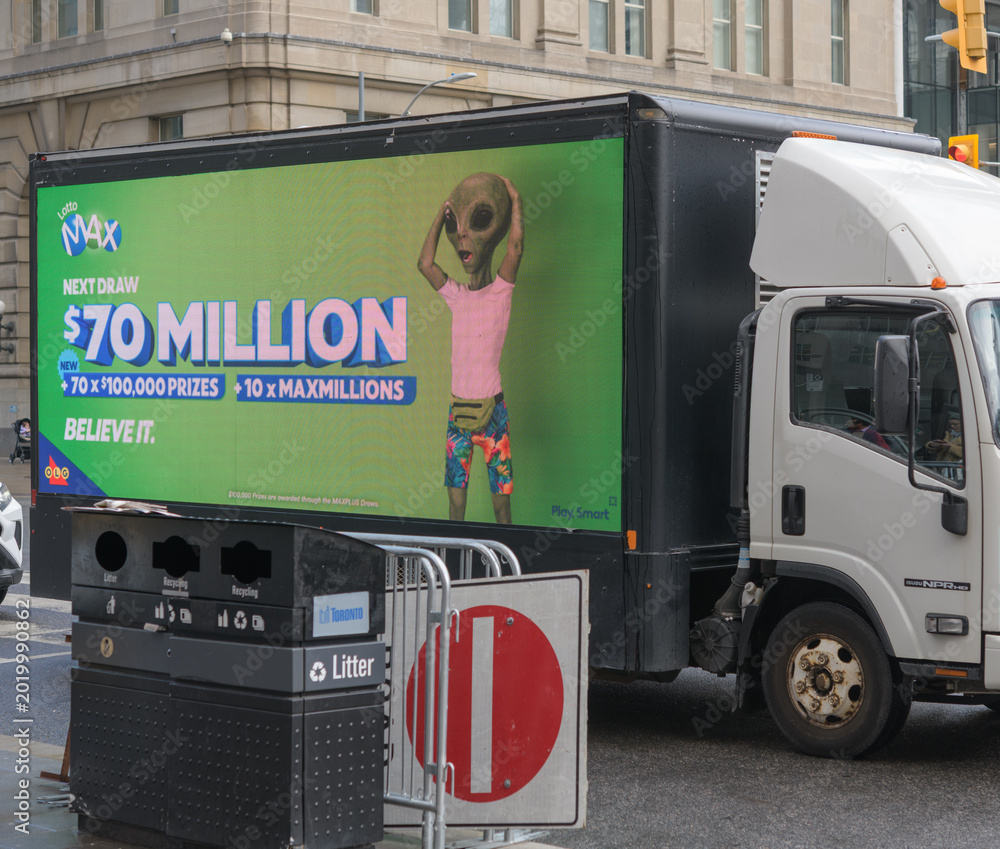 Naklejka premium mobile digital billboard truck displaying advertisements on Front St W (LottoMAX, Interprovincial Lottery Corporation), Toronto