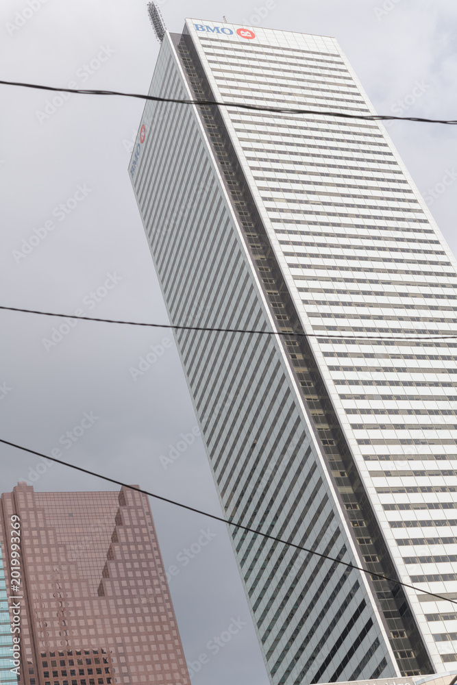 Naklejka premium abstract, oblique angle view of First Canadian Place, headquarters of BMO Group, and defocused view of Scotia Plaza, Toronto