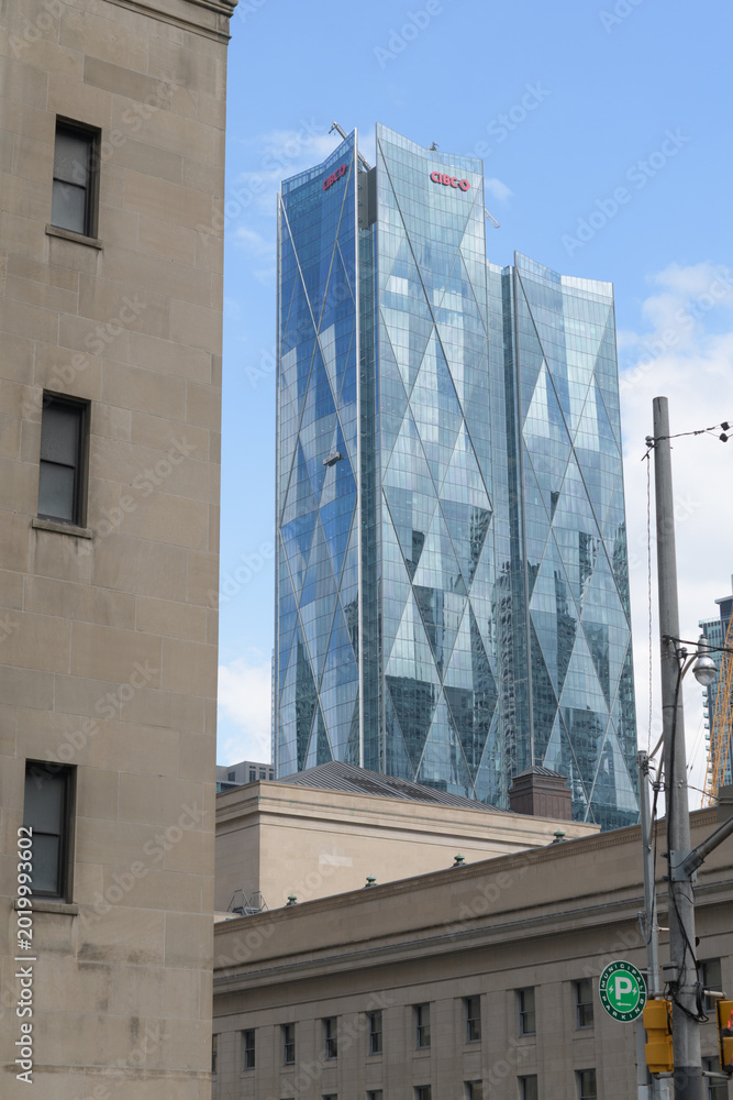 Fototapeta premium contrast of historic buildings and CIBC Square, designed by WilkinsonEyre + Adamson Associates, headquarters of Canadian Imperial Bank of Commerce, looking southeast from Front St W, Toronto