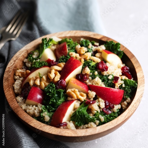 Fresh Salad With Quinoa, Apples, Walnuts, and Kale Served in a Wooden Bowl on...