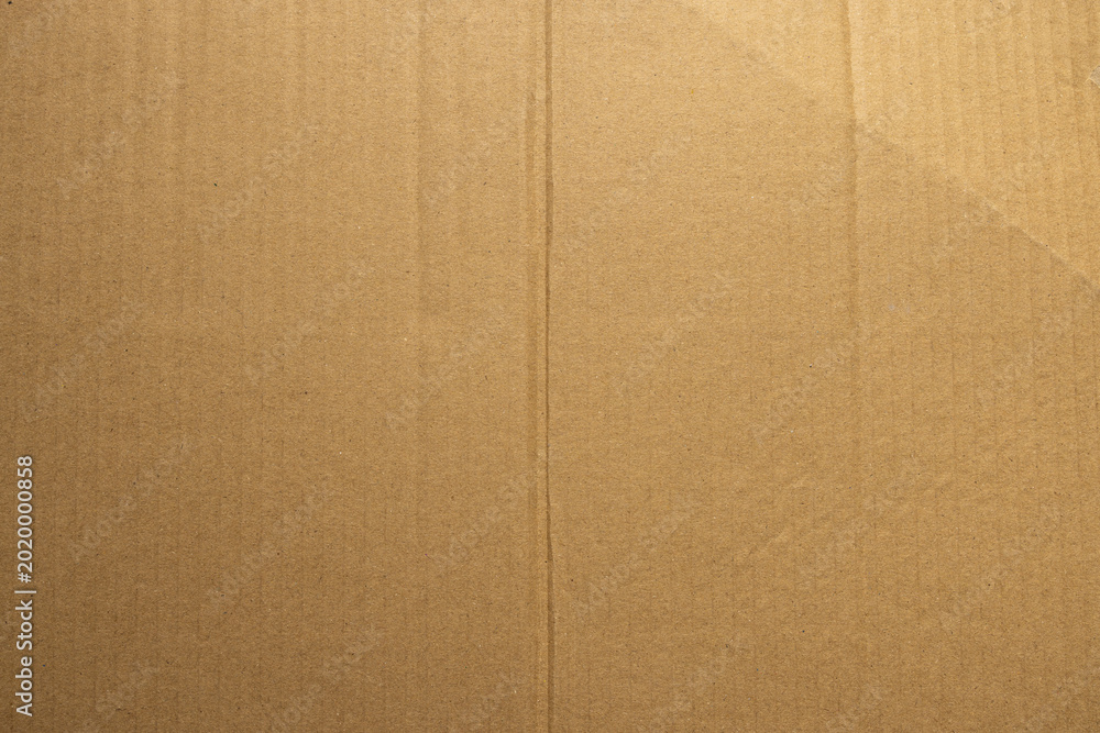 Fototapeta premium Brown Corrugated Cardboard Texture Background with Recycled Paper Fibers,Macro,Close-up macro shot of brown corrugated cardboard texture, showing detailed recycled paper fibers and natural organic.