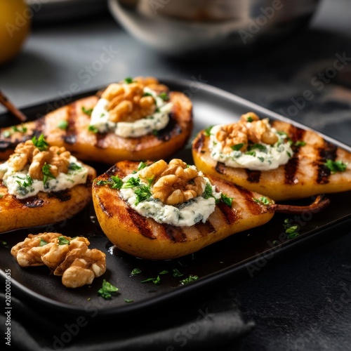 Grilled Pears With Cheese and Walnuts Served on a Black Plate