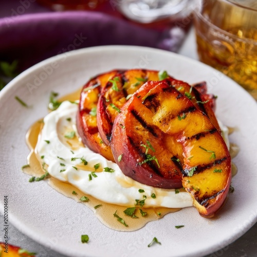 Grilled Peaches on Yogurt With Honey and Herbs Served on a Plate