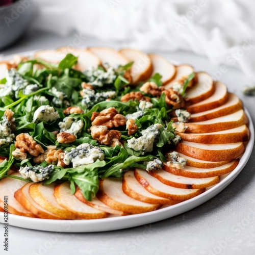 Healthy Salad With Pear Slices, Walnuts, and Blue Cheese on a Round Plate Dur...