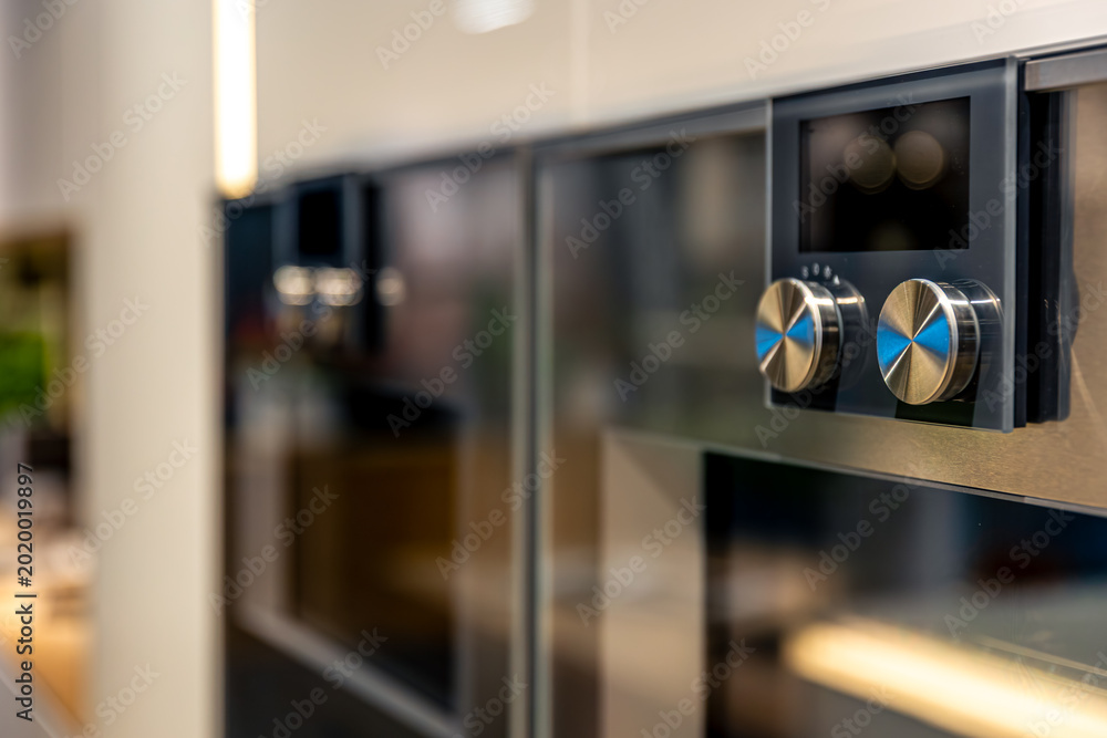 Konstfotografi Built-in oven details with metallic knobs