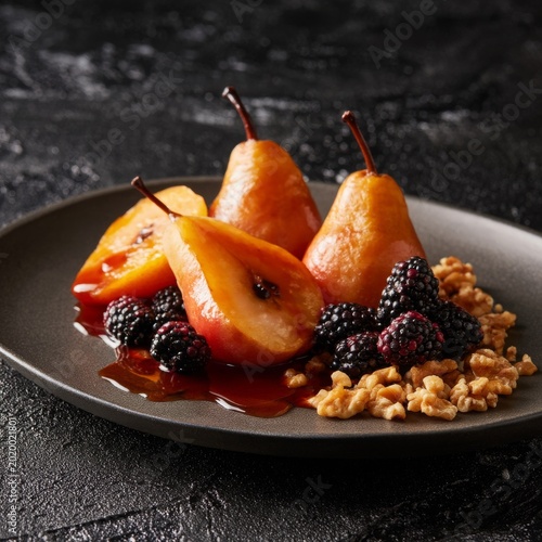Sliced Peaches With Blackberries and Walnuts on a Black Plate During a Meal