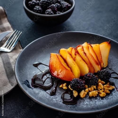Sliced Peaches With Blackberries and Walnuts on a Black Plate During a Meal