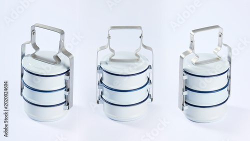 Konstfotografi Three views of a traditional white enamel pinto or tiffin food container