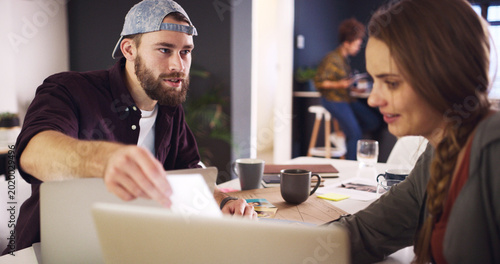Discussion  meeting or man with paper in creative agency  online magazine production or story review. Talking  people and editor with laptop for arrangement planning  feature format idea and teamwork