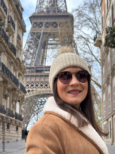 Woman traveling in paris visiting eiffel tower during winter
