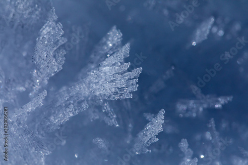 Bild auf Leinwand strato superficiale di un terreno coperto da cristalli di neve illuminati dal so