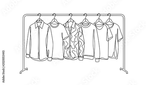 Obraz na plátne Clothing rack with hanging shirts