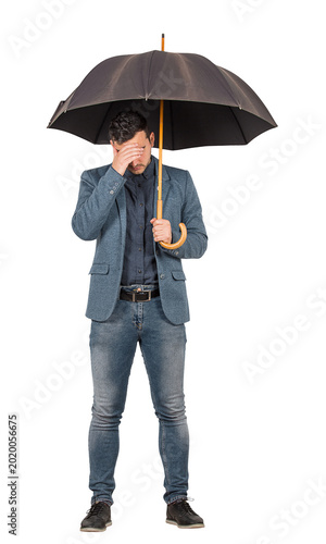 Foto Full length portrait of sad and pessimistic businessman standing under open umbr