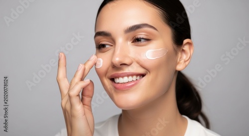 Young Woman Applying Moisturizing Cream to Her Face for Skincare.