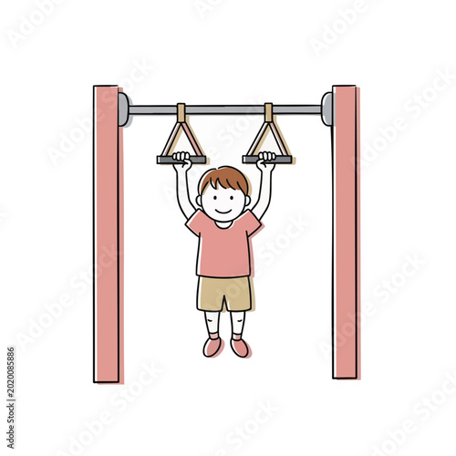 Boy hanging from gym rings and smiling in a playful setting  