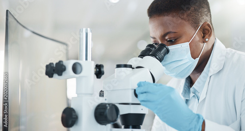 Obraz na płótnie Black woman, mask and microscope for scientist with sample for medical research or pharmacy in lab