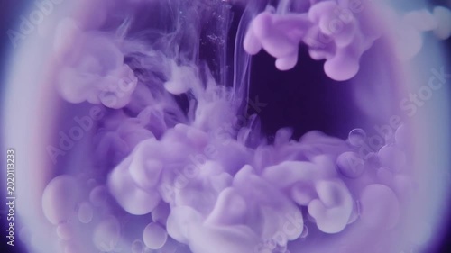 Purple Ink Cloud Swirling in Water with Rising Bubbles