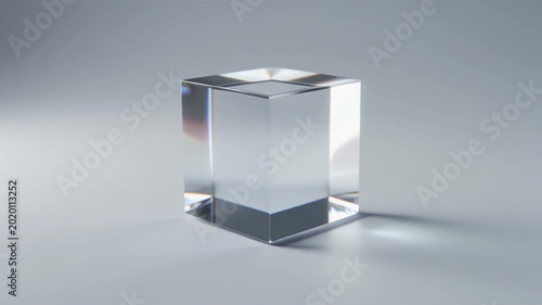 Rotating Transparent Glass Cube on Neutral Gray Background