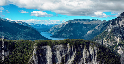Wide landscape of a winding blue lake between majestic mountain ranges in the Argentine Patagonia.