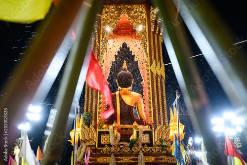 Photos Pouring water to worship Phra Fon Saen Ha Buddha statue during Inthakin Flower F