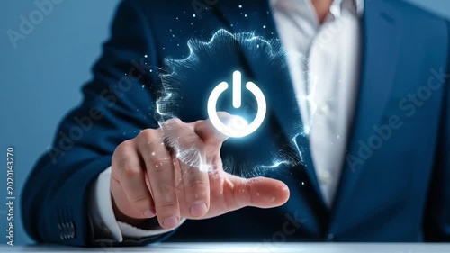 Close-up of a man's finger pressing a glowing power button on a digital interface