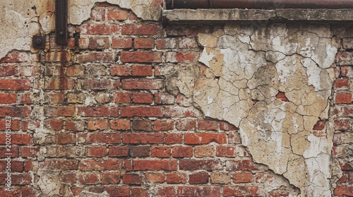 Obraz na plátně Close-up of old weathered brick wall with peeling plaster and rusty pipe