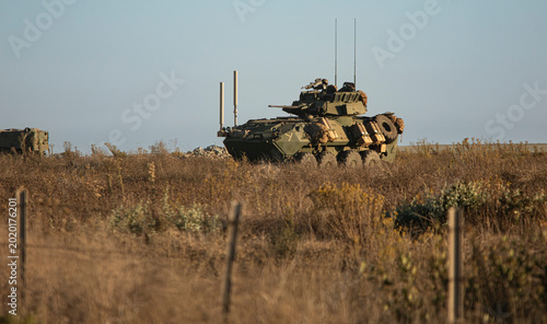 Side view of a United States Marine amphibious combat vehicle training in a field