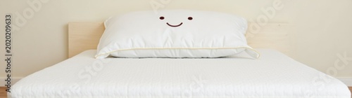 Pillow that is sitting on a bed with face a on it