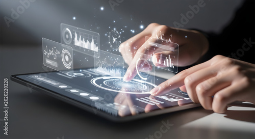 Futuristic digital interface on a tablet with holographic charts and data visualization hands interacting with advanced technology for innovation and analytics dark background