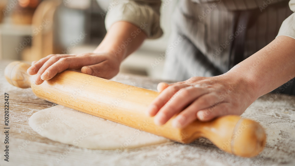 Fototapeta premium Kneading dough at the kitchen table