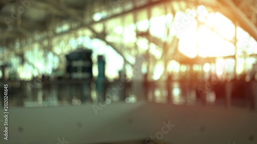 Blurred airport terminal with passengers walking and modern architecture creating an abstract and dynamic atmosphere