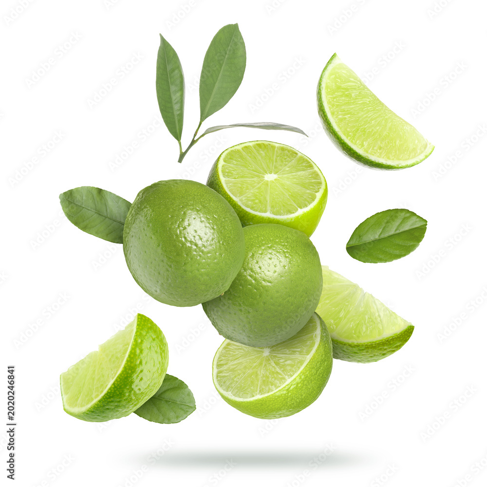 Naklejka premium Fresh limes and green leaves falling on transparent background. Citrus fruit