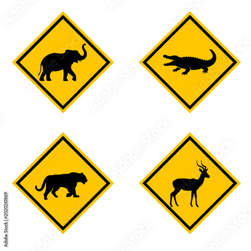 Photography Set of four yellow diamond-shaped warning signs featuring silhouettes of various
