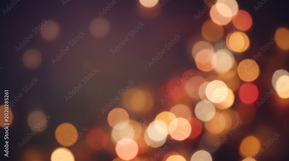 Obraz premium Abstract celebration background with warm festive lights bokeh effect and copy space