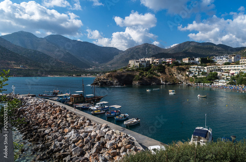 Fotografie Beautiful coastal harbor with fishing boats, turquoise sea and mountain landscape on Crete island, Greece