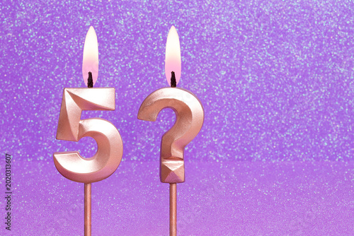 Number 5 and question mark on a pink background with blurred bright dots - Birthday or anniversary card with abstract blurred dots that glow