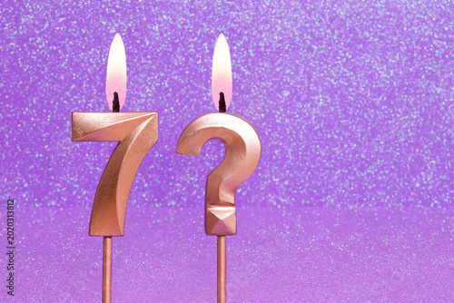Number 7 and question mark on a pink background with blurred bright dots - Birthday or anniversary card with abstract blurred dots that glow