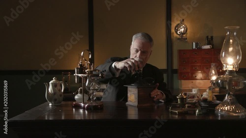 19th century businessman grinding coffee at his desk