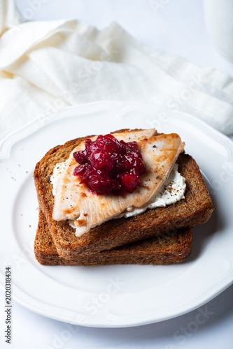 Open Sandwich with leftover turkey slices with cranberry sauce on top. Perfect holiday breakfast or lunch