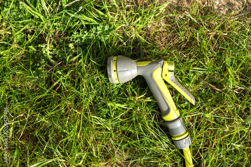 Bilde på lerret Watering tool laying on lawn in residential garden