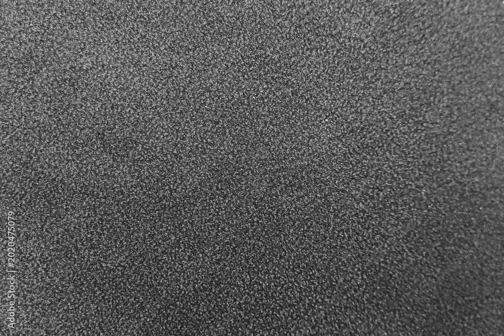 Fototapeta premium Dark gray synthetic leather texture background with fine grain detail.