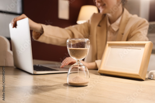 Hourglass near businesswoma...