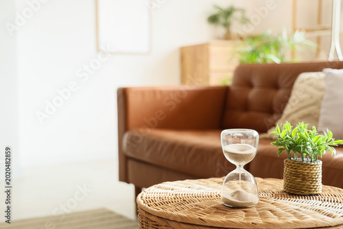 Hourglass and houseplant on...