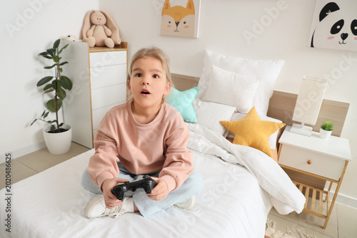 Cute little girl playing vi...