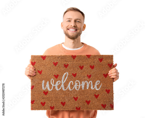 Young man with doormat on w...