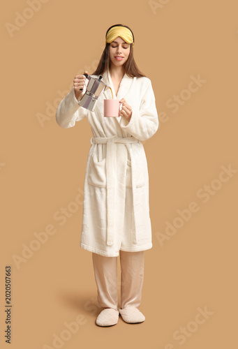 Young woman in bathrobe and...