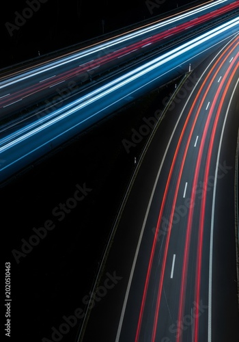 A top-down view of a highway with vibrant motion blur trails, featuring a minimalist layout and strong high-contrast zones for impact, backdrop, blank space, urban