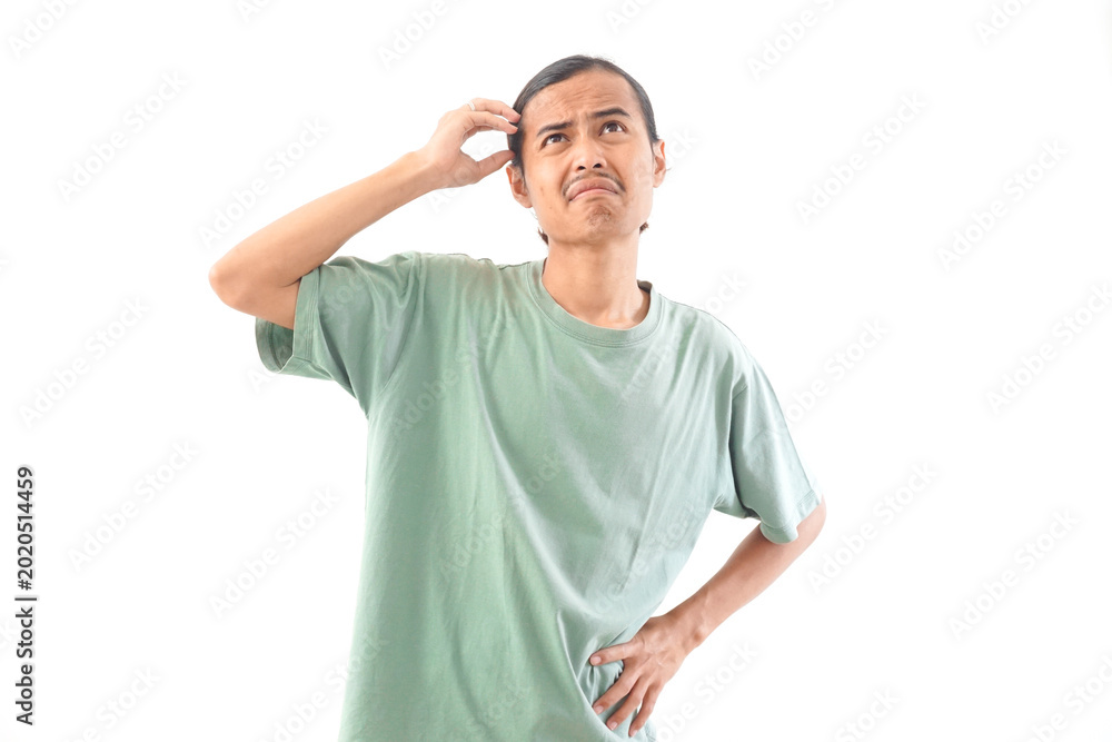 Fototapeta premium young handsome Indonesian, Asian man in green shirt confusion face and gesture isolated on white background. Feeling clueless and confused