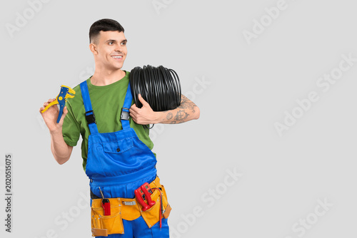Young male electrician with...