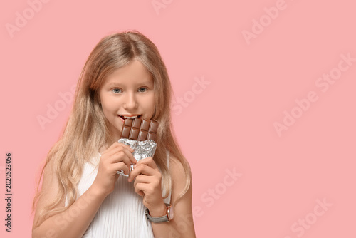 Cute little girl eating swe...
